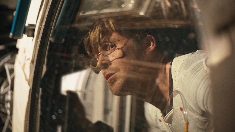 Ryan Gosling as Ryland Grace staring out the window of his spaceship in Project Hail Mary
