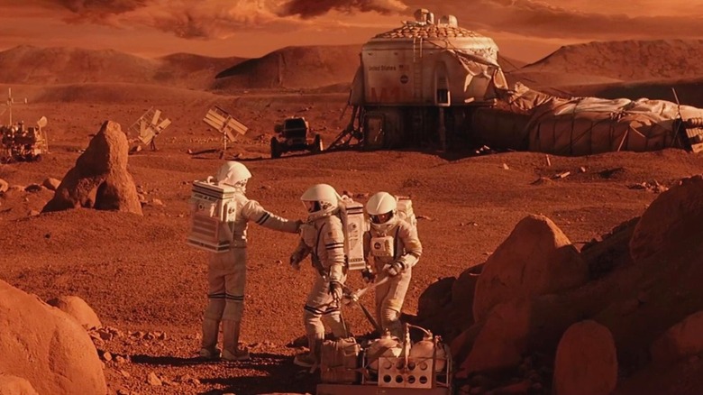 Astronauts near an outdoor enclosure in Mission to Mars