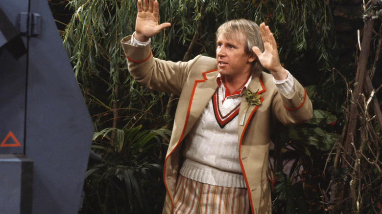 The Fifth Doctor with his hands up on Doctor Who