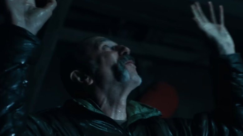Ray Stoker inside his cabin with his hands up in Anemone