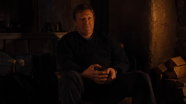 Jem Stoker sitting in a chair listening to his brother in Anemone