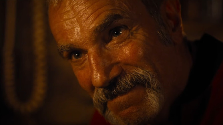 A close-up of Daniel Day-Lewis as Roy Stoker on the verge of laughing during a heated conversation in Anemone