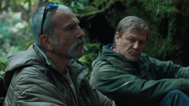 Daniel Day-Lewis as Ray Stoker sitting in the woods next to Sean Bean as Jem Stoker in Anemone