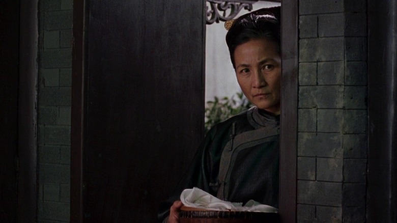 Pei Pei Cheng as Jade Fox in Crouching Tiger Hidden Dragon lurking behind door
