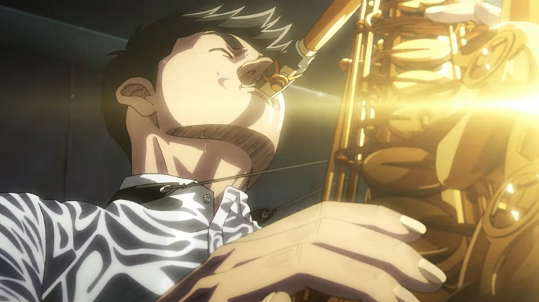 Dai Miyamoto blows hard on saxophone as it catches the light in Blue Giant