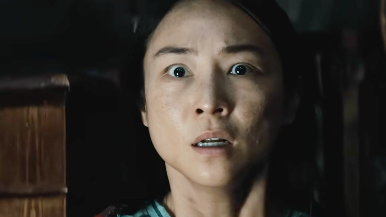 Greta Lee as Ann looking scared in The Last House