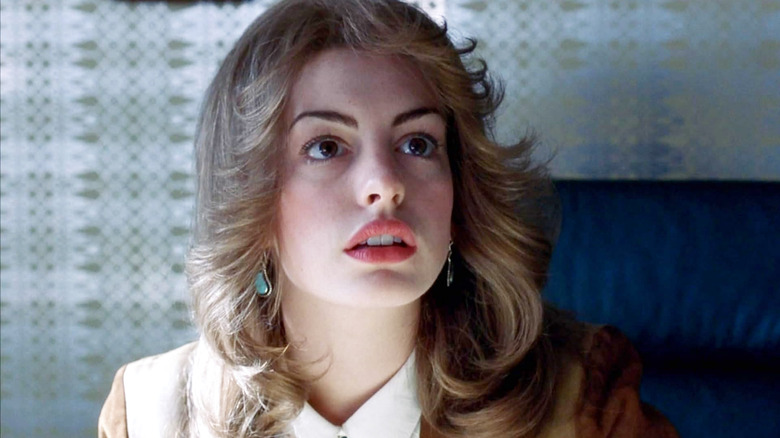 Lureen wearing a jacket and sitting in a blue chair in Brokeback Mountain