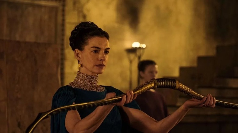Penelope holding Odysseus' hunting bow in The Odyssey