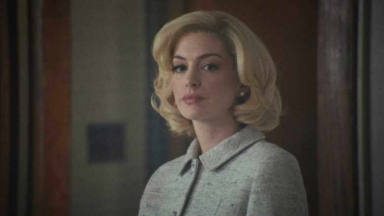 Anne Hathaway's Rebecca Saint John stares into the distance in Eileen