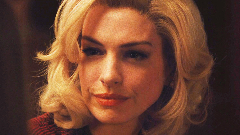 Anne Hathaway's Rebecca Saint John smiles in closeup in Eileen