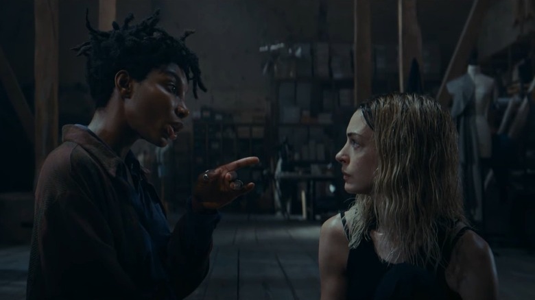 Anne Hathaway as Mother Mary sitting next to Michaela Coel as Sam pointing a finger at her in Mother Mary