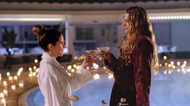 Anna Kendrick as Stephanie and Blake Lively as Emily drinking martinis by the pool in Another Simple Favor