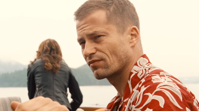 Til Schweiger's Jack Carver steers a boat in Far Cry