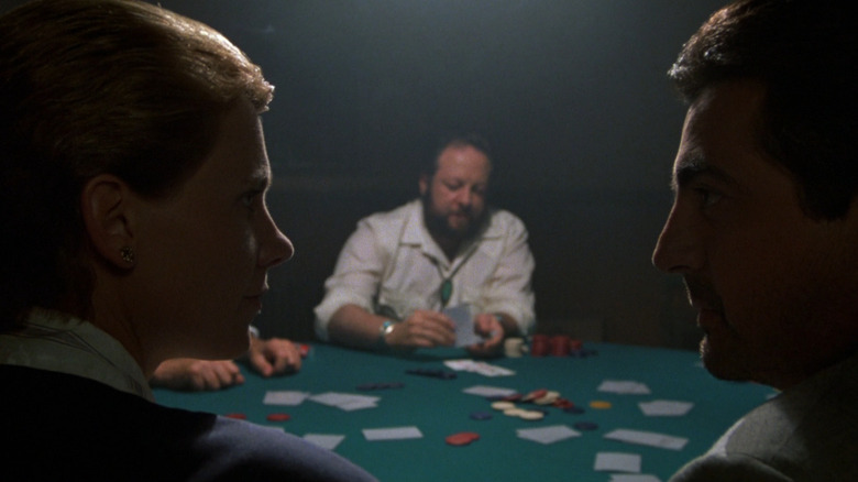 Dr. Margaret Ford (Lindsay Crouse) and Mike Mancuso (Joe Mantegna) scheme as George (Ricky Jay) waits for a poker hand in House of Games