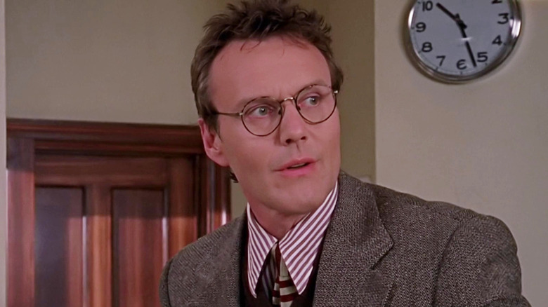 Rupert Giles stands in the library in Buffy the Vampire Slayer