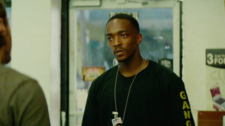 Anthony Mackie as Marcus Belmont looking frustrated in a convenience store in Triple 9