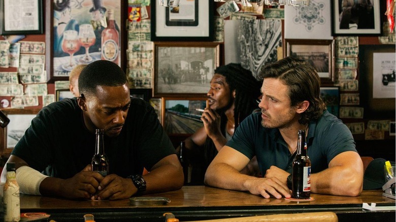 Anthony Mackie as Marcus Belmont sitting at a bar with Casey Affleck as Chris Allen in Triple 9