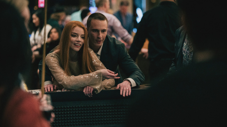 Anya Taylor-Joy's Lucky Armstrong stands with Drew Starkey's Cary Matheson at a craps table in Lucky