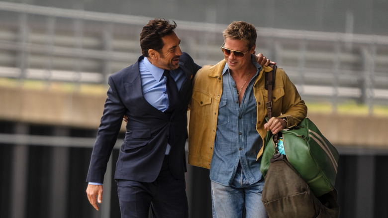 Javier Bardem as Ruben putting his arm around Brad Pitt as Sonny in F1: The Movie