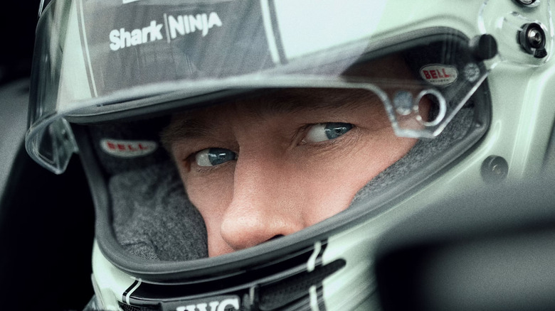 A close up of Brad Pitt as Sonny in his racing helmet on the poster for F1: The Movie