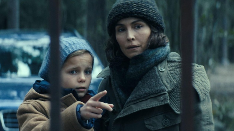 Noomi Rapace as Jo holding her daughter Alice in Constellation