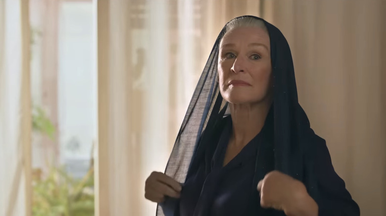 Glenn Close's Marjan Montazami stands by a window in Tehran