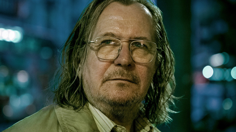 Gary Oldman's Jackson Lamb is seen in closeup as he stands outside in Slow Horses.jpg