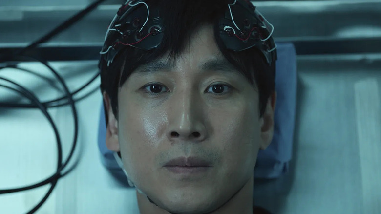 Sewon Koh (Lee Sun-kyun) has his brain wired to a device in Dr. Brain