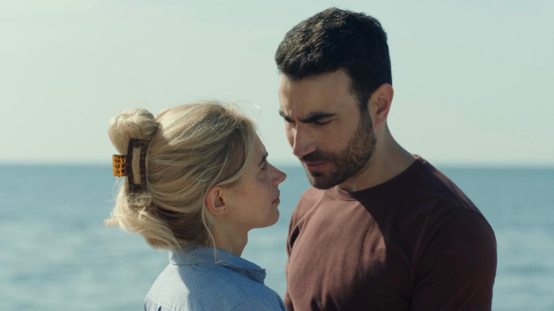 Imogen Poots as Laura and Brett Goldstein as Simon staring into each other's eyes on the beach in All of You