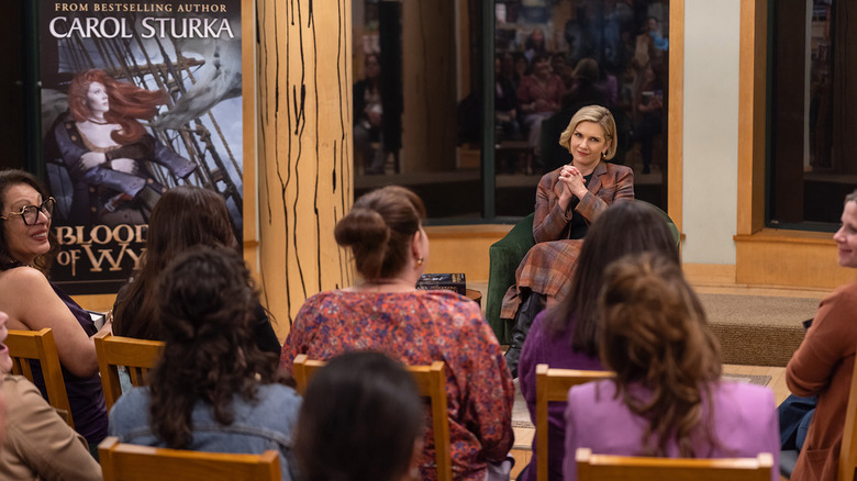 Rhea Seehorn's Carol Sturka hosts a live reading event for her book in Pluribus