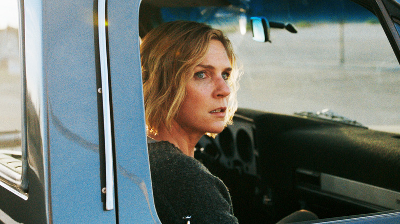 Rhea Seehorn's Carol Sturka sits looking out of a truck window in Pluribus