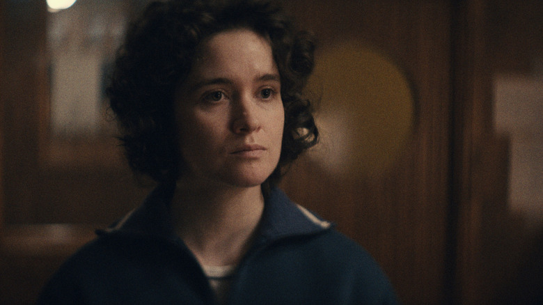 Alice Englert as Anastasia Belikova wearing her astronaut's uniform while standing in an office in Star City