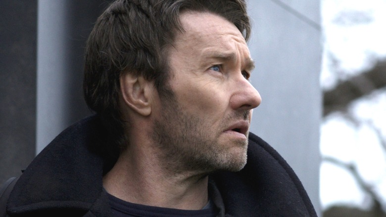 Joel Edgerton as Jason Dessen wearing a heavy jacket and standing outside in Dark Matter