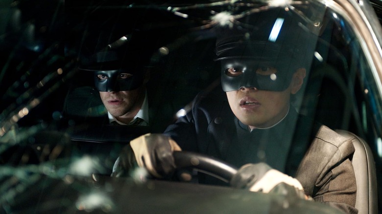 Britt Reid and Kato looking shocked behind a bullet-riddled windshield in The Green Hornet (2011)