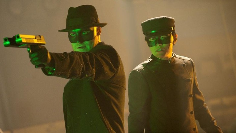 Britt Reid pointing his gun while Kato looks on in The Green Hornet (2011)