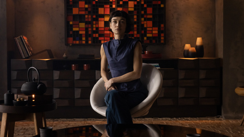 Wendy sitting in a chair with a tea kettle beside her in Alien: Earth