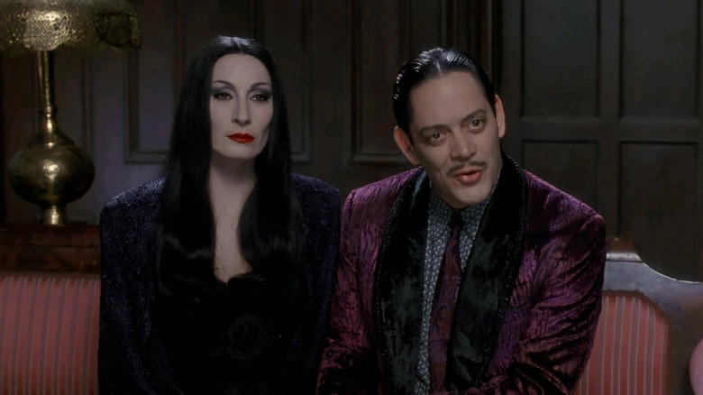 Gomez and Morticia sitting on a couch in The Addams Family movie