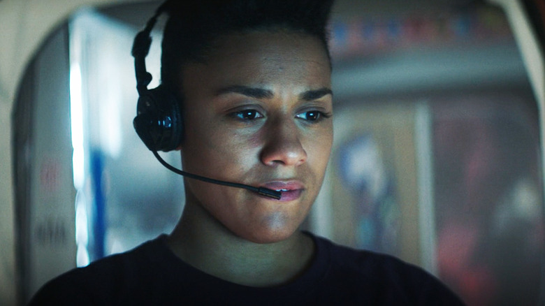 Ariana DeBose's Dr. Kira Foster looks worried while wearing a headset in I.S.S.