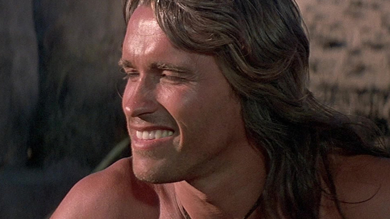 Arnold Schwarzenegger as Conan grinning in the sun in Conan the Barbarian