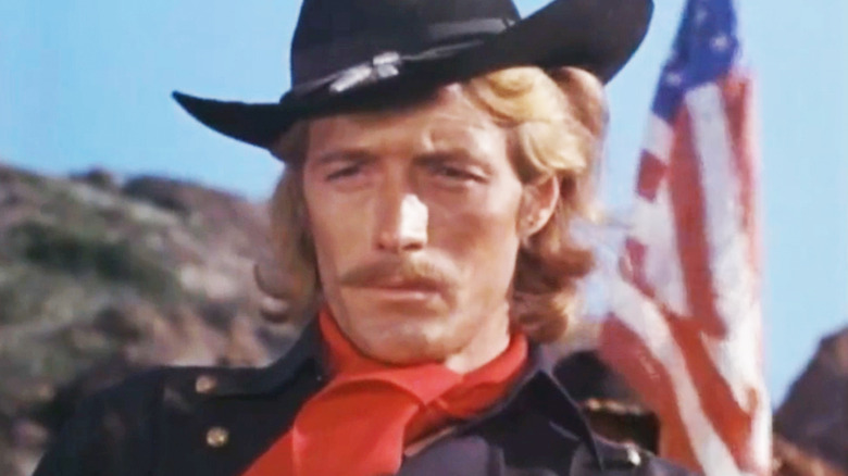 Wayne Maunder's Lieutenant Colonel George Armstrong Custer is seen in closeup with a U.S. flag in the background in Custer