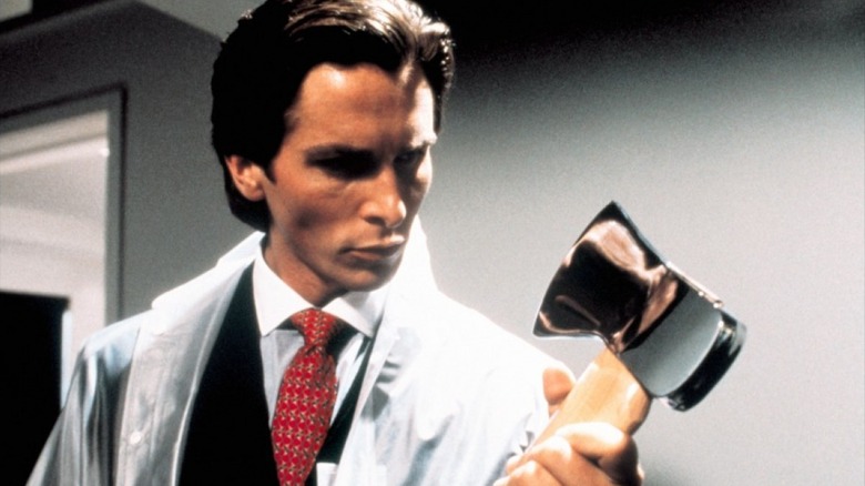 Christian Bale as Patrick Bateman staring at his axe in the original American Psycho
