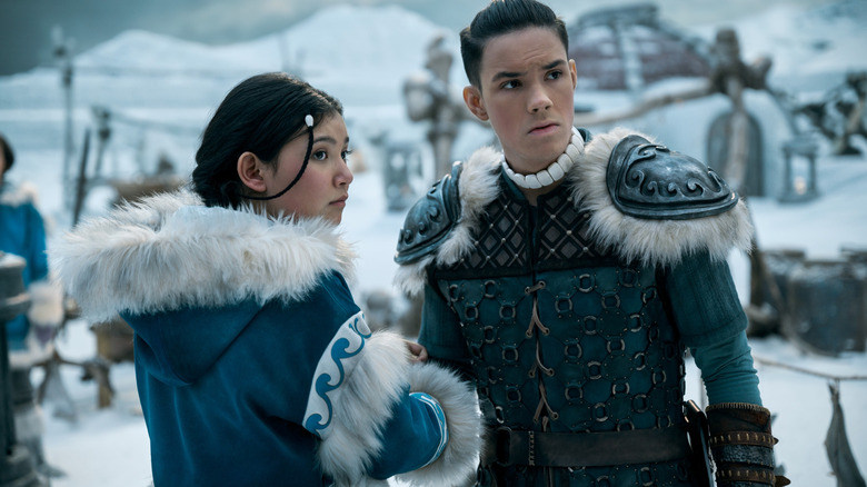 Kiawentiio as Katara and Ian Ousley as Sokka standing in the snow in season 1 of Netflix's Avatar: The Last Airbender