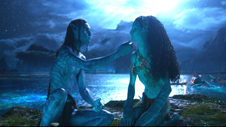 Britain Dalton as Lo'ak caressing the face of Bailey Bass as Tsireya in Avatar: Fire & Ash
