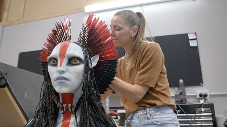 A member of Deborah L. Scott's costuming crew works on Varang's headdress in a behind-the-scenes featurette for Avatar: Fire and Ash