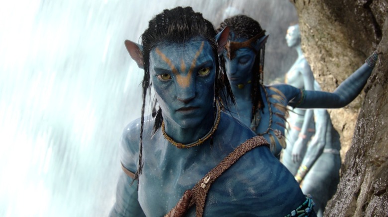 Sam Worthington as Jake Sully walking under a waterfall in Avatar