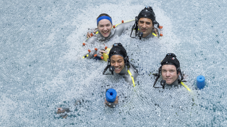 The cast of Avatar: The Way of Water in a water tank