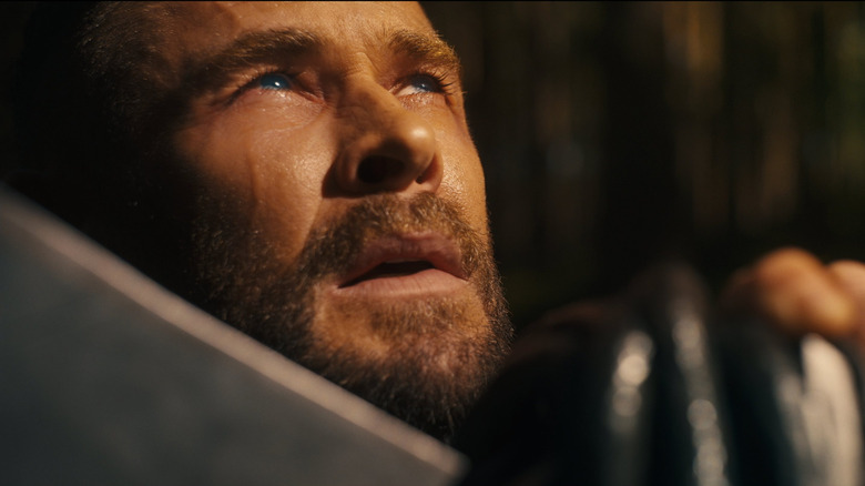 Chris Hemsworth as Thor crouched down holding his ax in Avengers: Doomsday