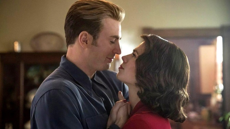 Chris Evans as Steve Rogers embracing Hayley Atwell as Peggy Carter while dancing in their home in Avengers: Endgame