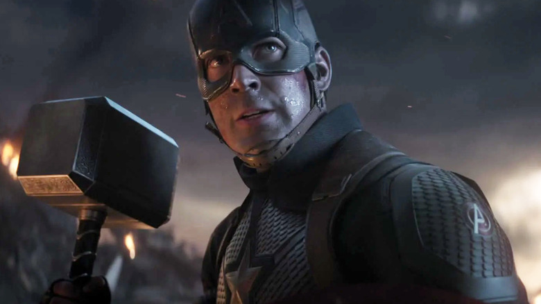 Chris Evans as Captain America holding Thor's hammer in Avengers: Endgame