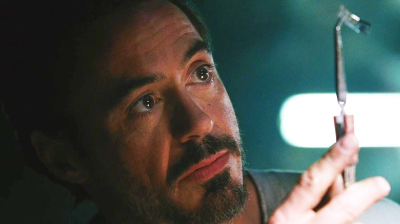 Robert Downey Jr. as Tony Stark building his suit in a cave in Iron Man